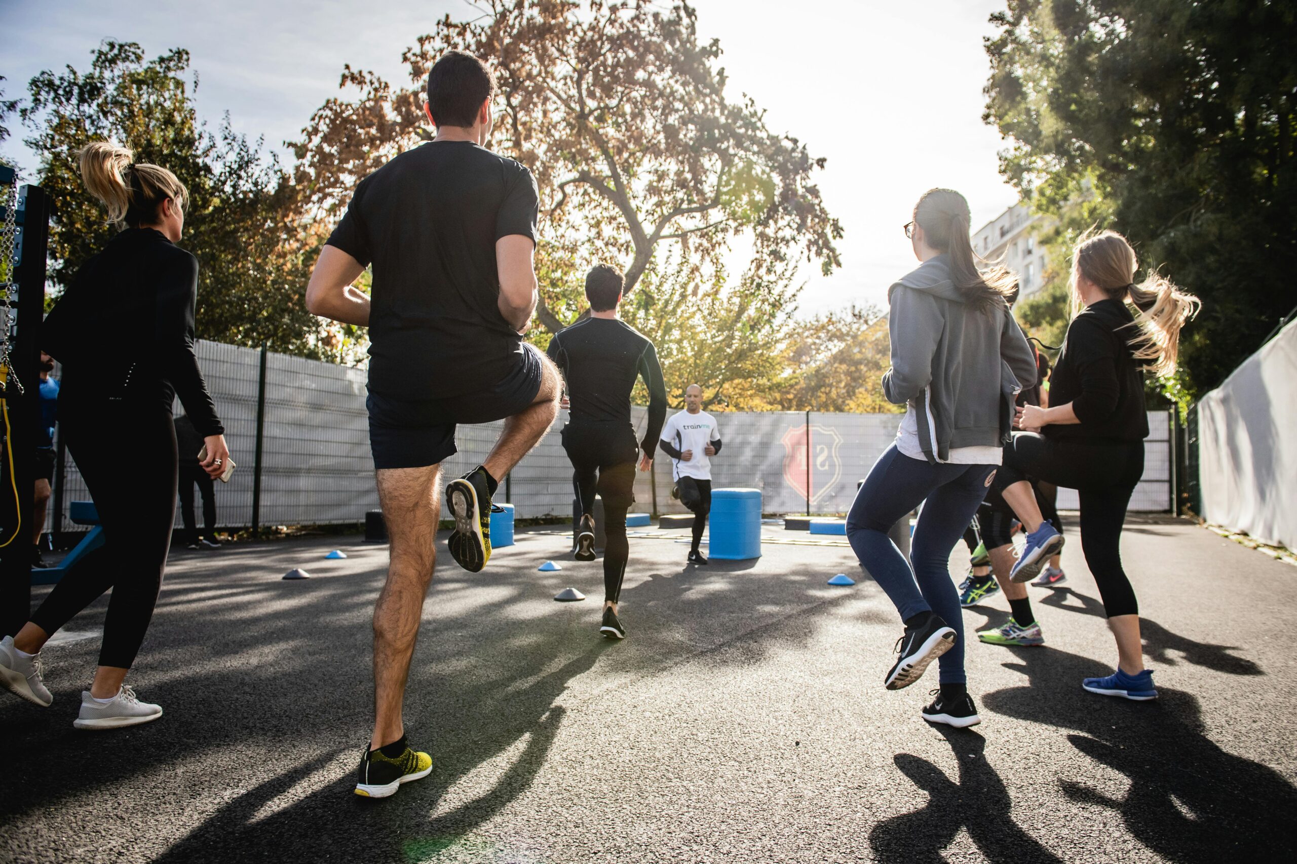 Active group participating in an outdoor fitness session in Boulogne-Billancourt, France.